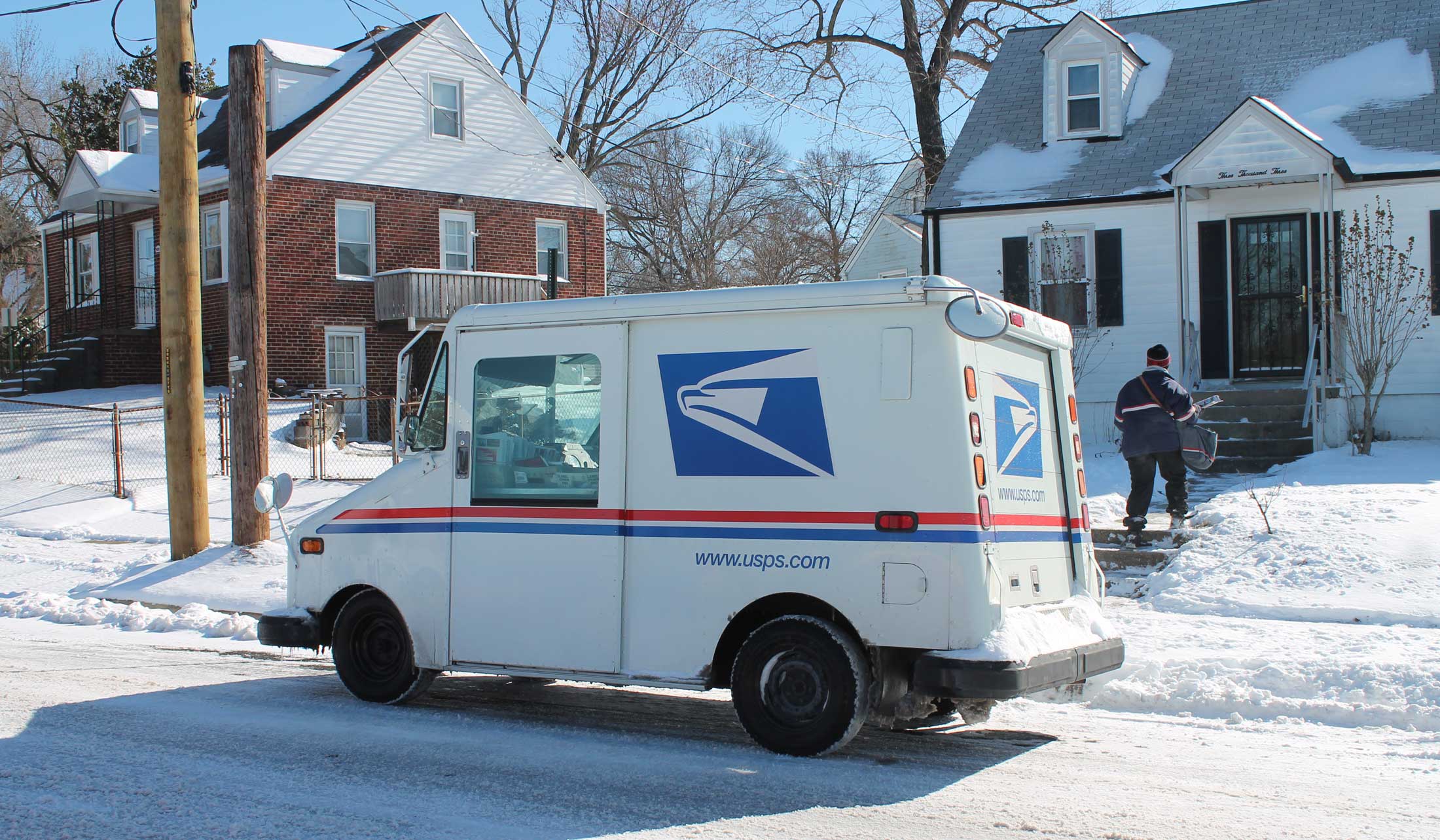Mailman and Mail Truck in Winter