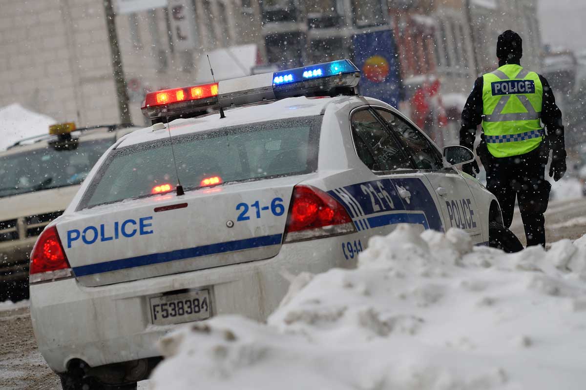 Policeman wearing ice cleats in the city.