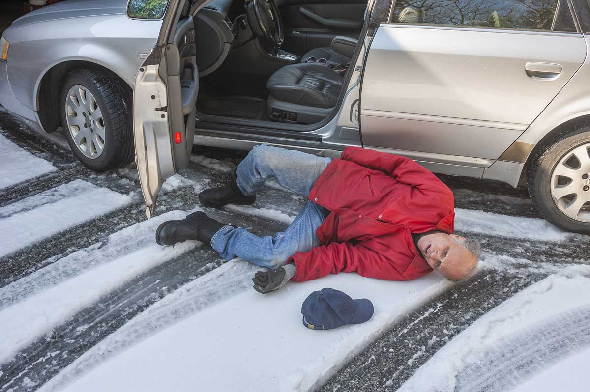 Senior, Elderly person slipping on ice getting out of car.